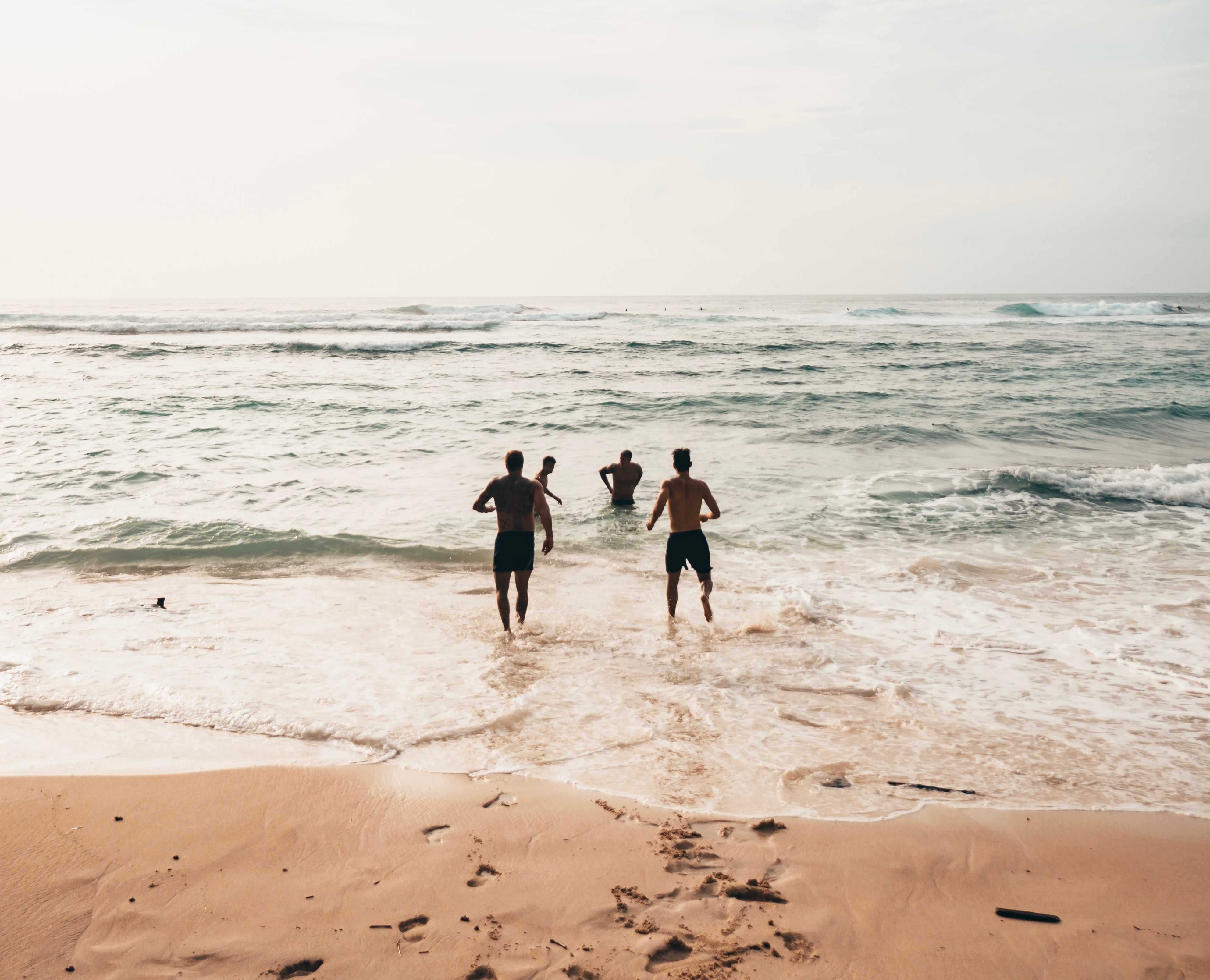 Group walking into beach by Oliver Sjostrom via Unsplash 